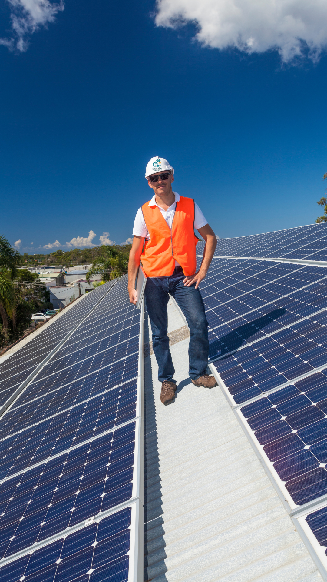 Technician installing solar panels on a Caribbean-style roof in Sosúa.